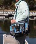 Calcutta tackle bag on fisherman's shoulder